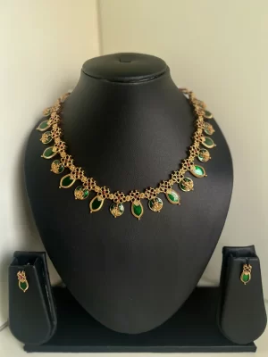 Antique gold Lakshmi and leaf drop palaka necklace set in dark green - S-cube Fashions